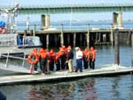 Sea Cadets line up on the dock, prior to jumping into 58º water with Survival Suits. Photo by CWO F. Woodward, NSCC